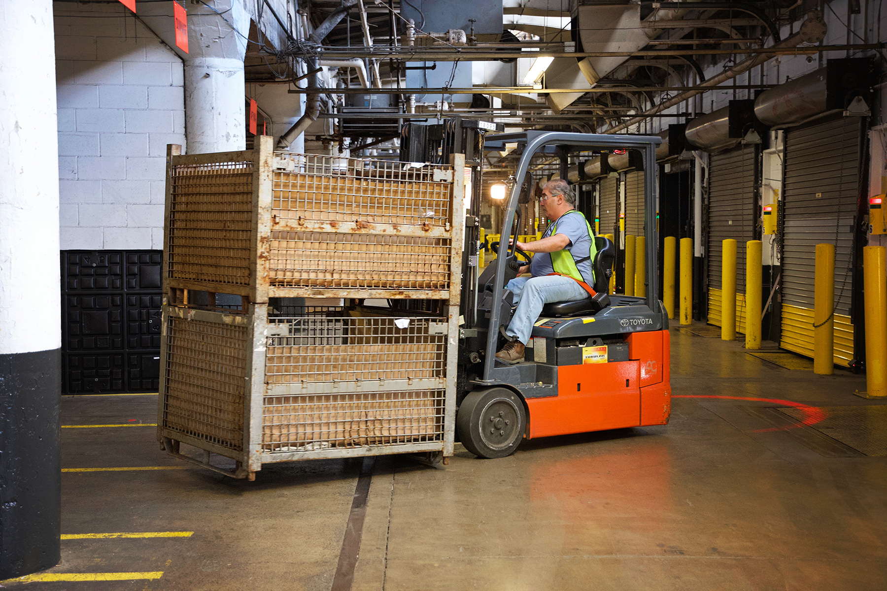 man operating fork lift in warehouse