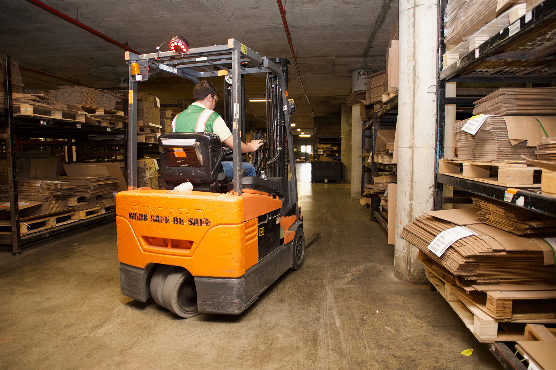 man driving forklift in warehouse